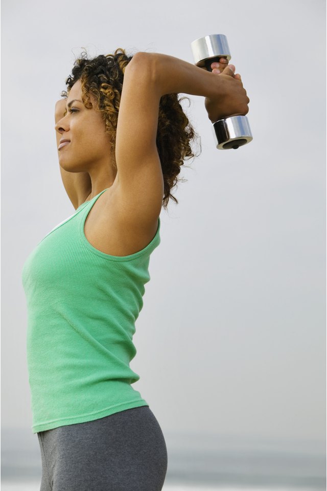 Woman doing triceps exercise with dumbbell