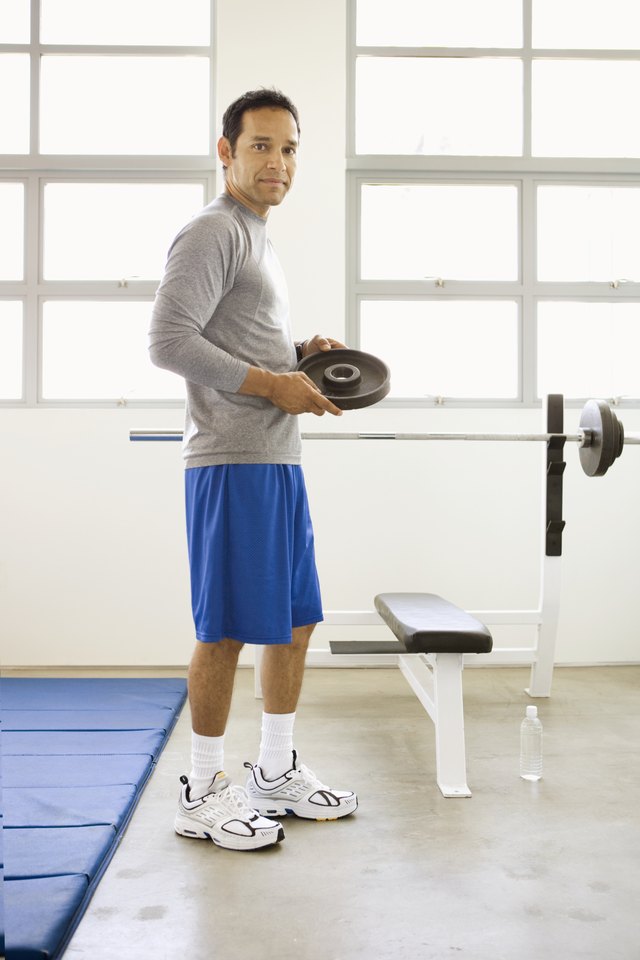 Man holding weight in gym