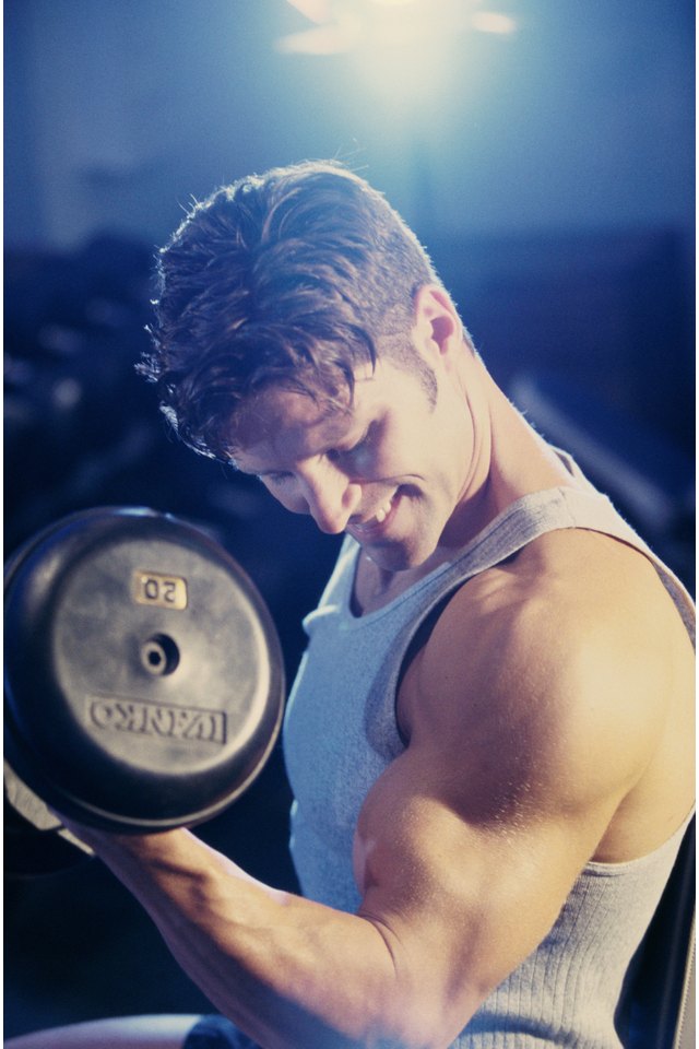 Young man exercising with dumbbells