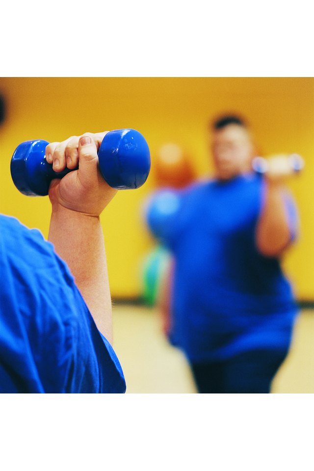 Close Up of an Overweight Man Weight Training in a Gym