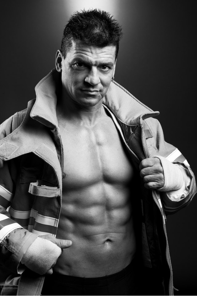 Muscular firefighter posing