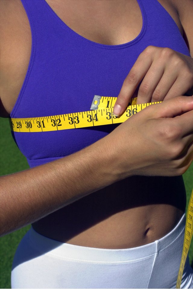 Woman measuring bust with measuring tape