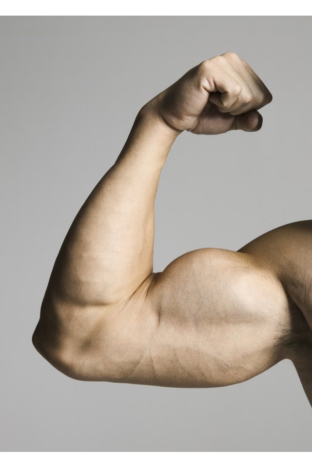 close up of a muscular male arm as he flexes his biceps