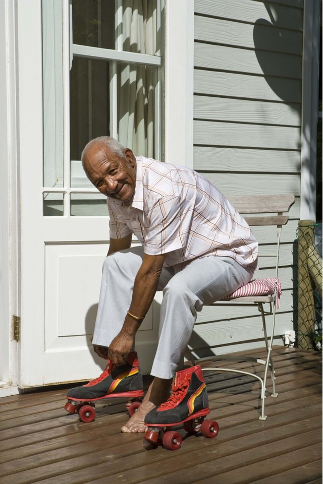 Senior man putting on roller skates
