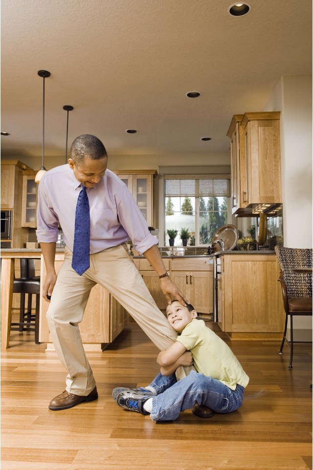 Boy clinging to father