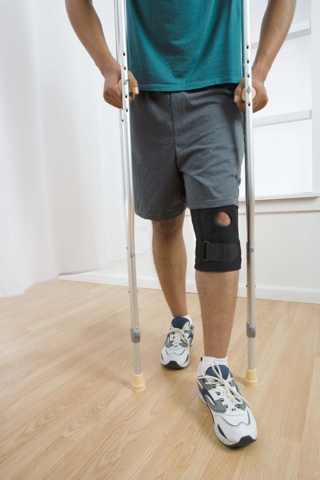 Man with knee brace and crutches
