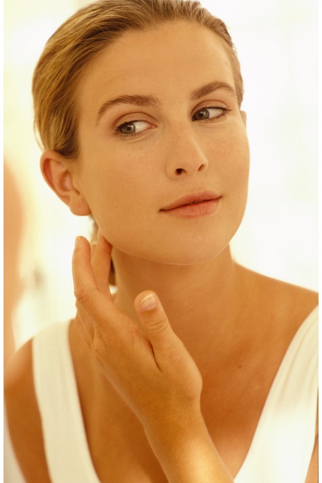 Woman applying skin cream