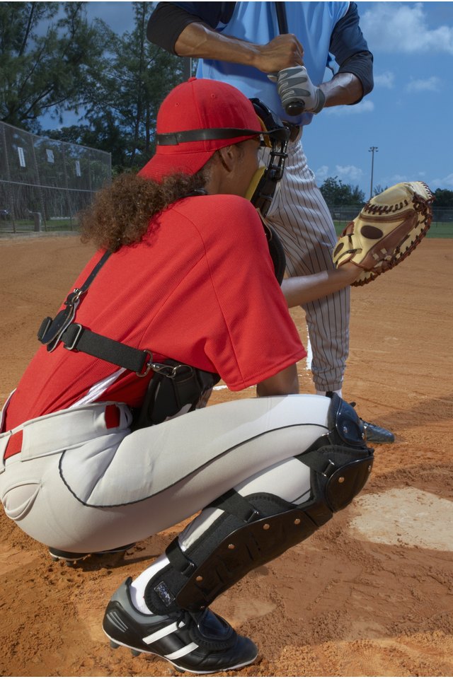 Baseball catcher crouching by batsmen