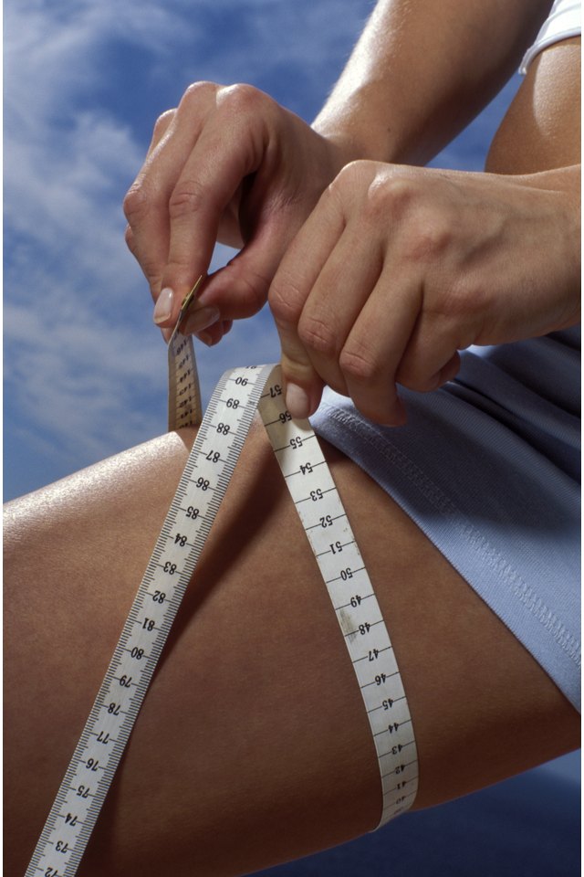 Woman measuring thigh