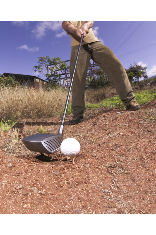 Man golfing in desert