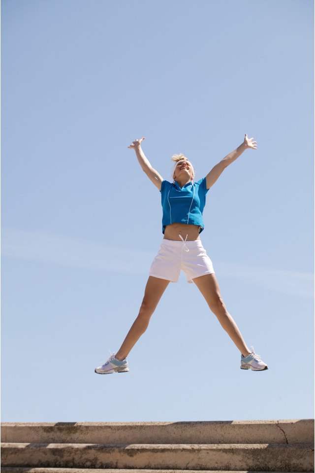 Woman jumping with arms outstretched