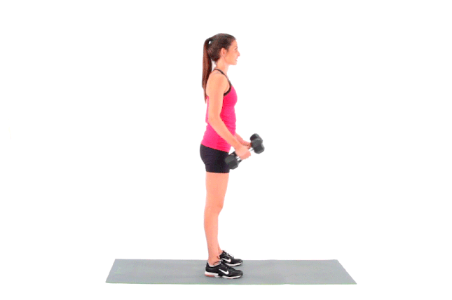 Young man exercising with dumbbell in gym