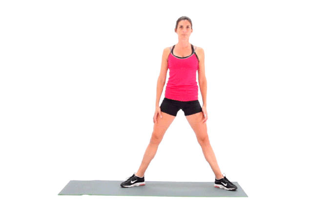Young woman in gym doing squats