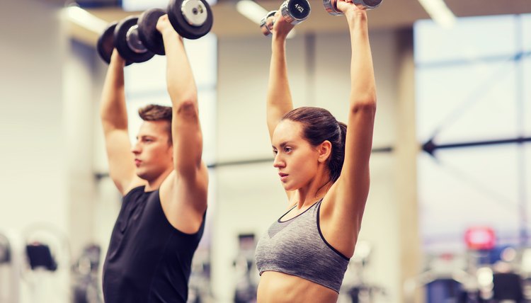man and woman lift weights
