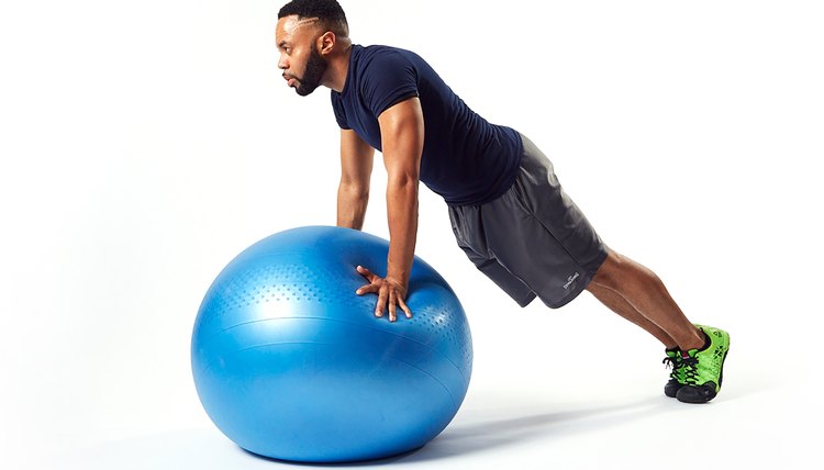 man doing a balancing plank on a swiss exercise ball