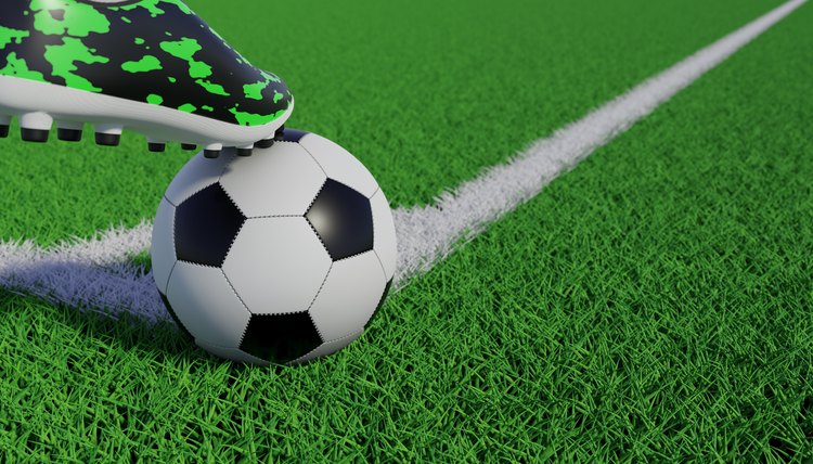 3d rendering of soccer ball on the edge of a soccer field lawn being stopped by a soccer boot.