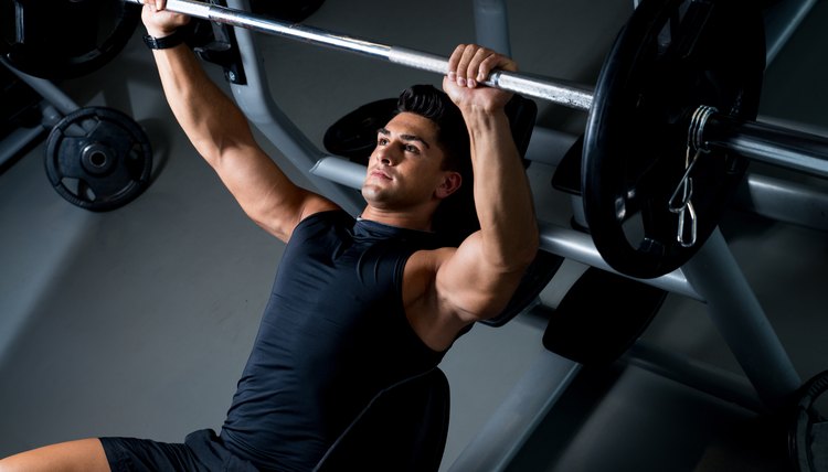 A man lifting weights on a bench press