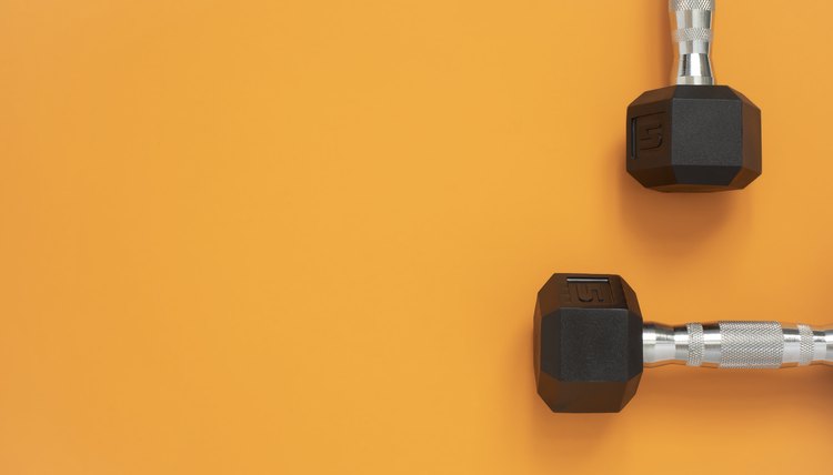 Two dumbbells on deep yellow
