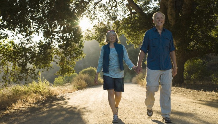 Mature couple walking down dirt road