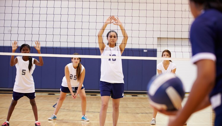 High School Volleyball Match In Gymnasium