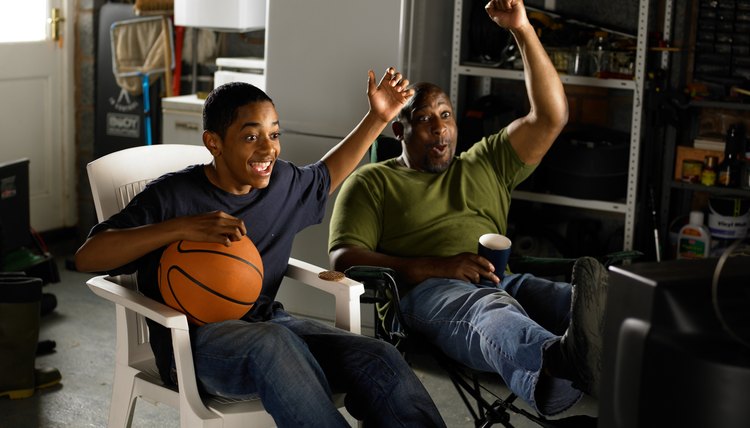 Father and Son watching TV and celebrating