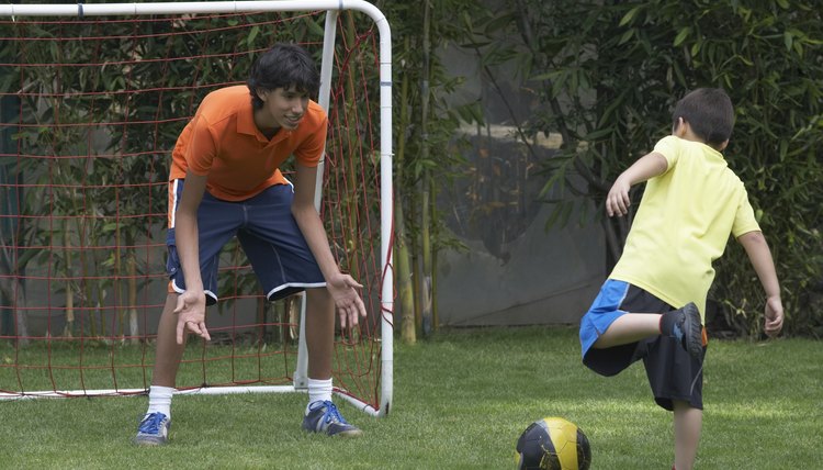 Two boys playing football