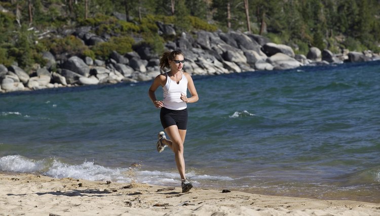 Woman running on beach, Lake Tahoe, California, USA