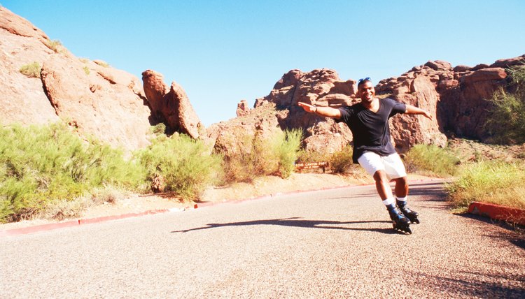 Man inline skating down on road