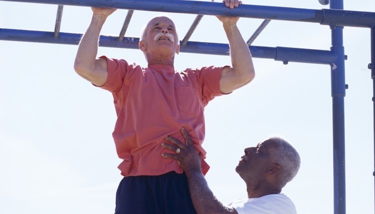 Man spotting another man doing a chin up