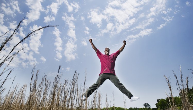 Man doing a jumping jack in field