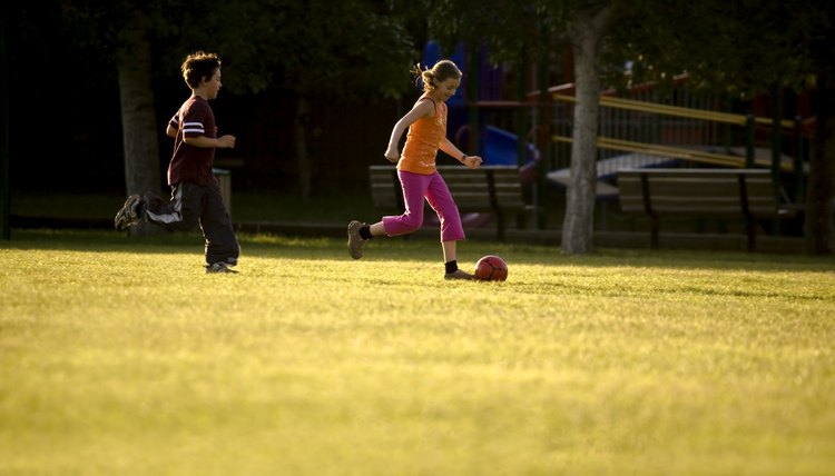Two kids playing soccer