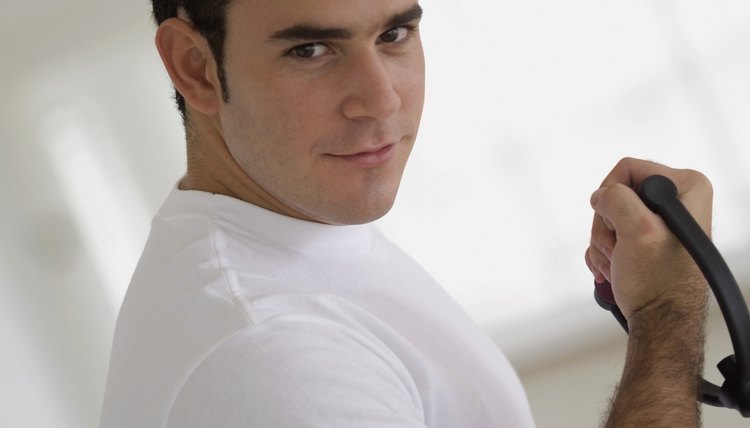Young man using resistance band, close-up
