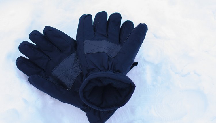 Snow gloves in winter season with snow background