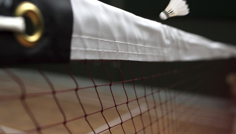 Shuttle badminton net up close and a fast moving shuttlecock