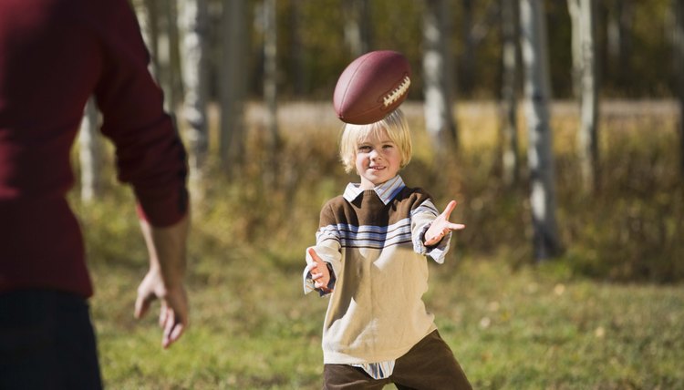 Father and son playing football