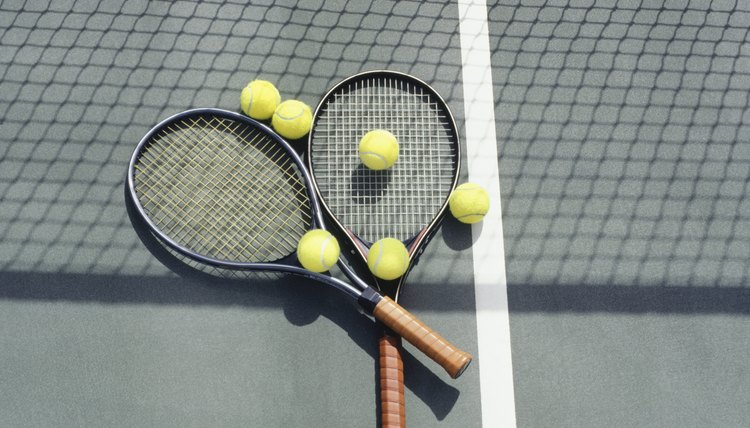 Tennis racquets and balls lying on court