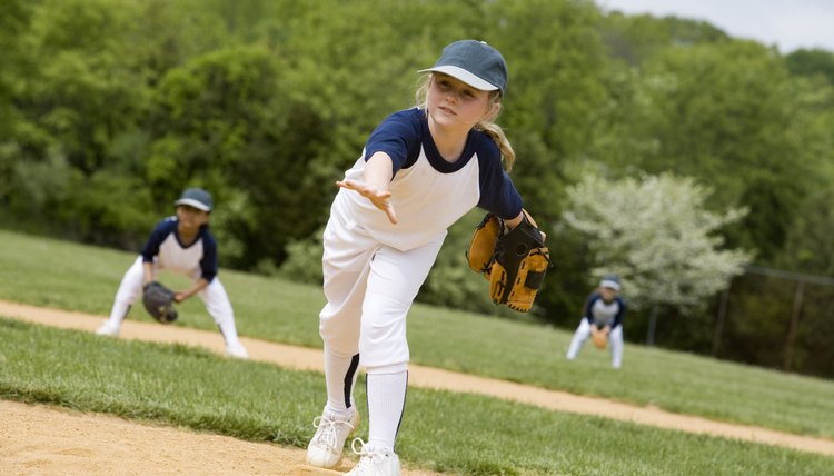 Girl throwing in little league softball game