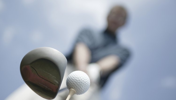 Man preparing to hit golf ball