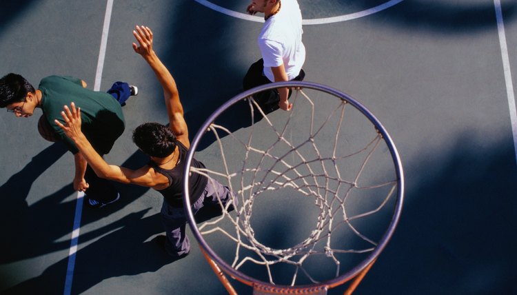 Three Teenage Boys Playing Basketball