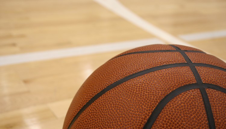 Basketball on the Hardwood of an Indoor Court