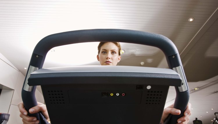 Woman on exercise bike at gym