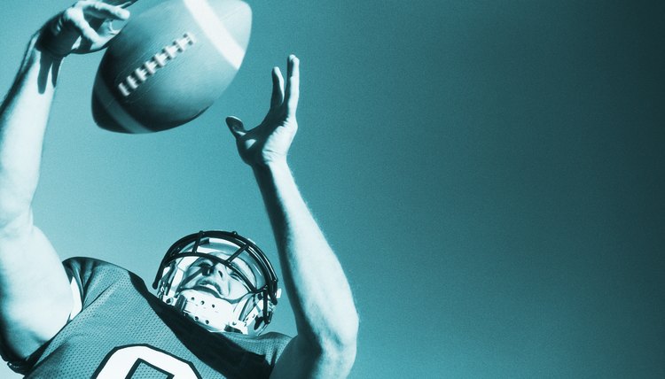 toned low angle view of a football player catching the ball