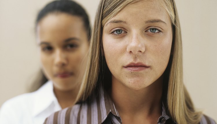 Two teenage girls standing in studio,portrait