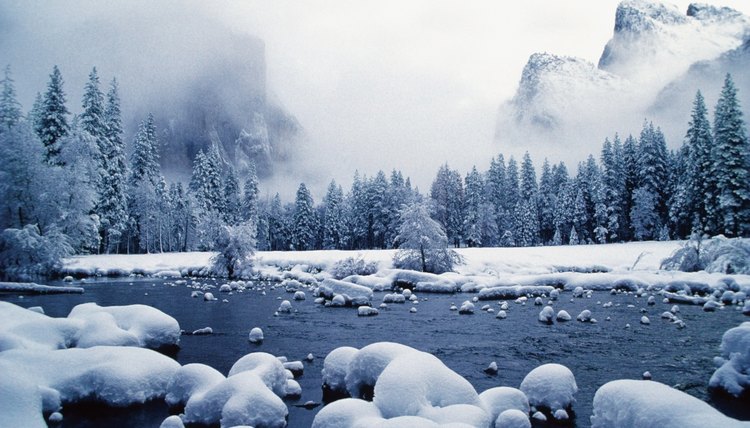 Snow covered mountain peaks and trees, Merced River, Yosemite National Park, Mariposa County, California, USA
