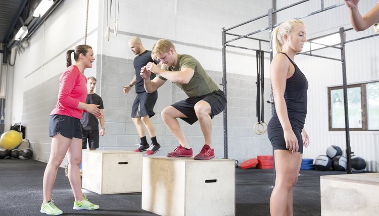 Workout group trains box jumps