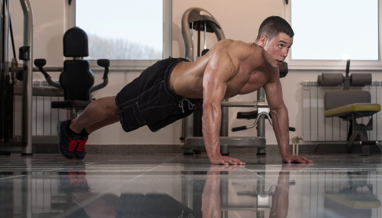 Young Man Doing Press Ups In Gym
