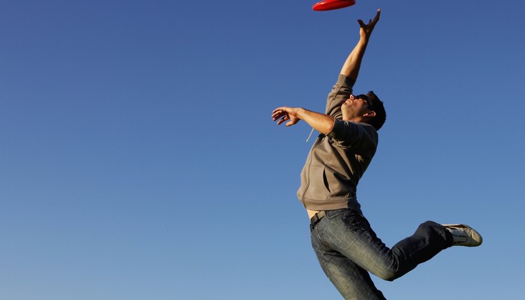 Man jumping to catch flying disc