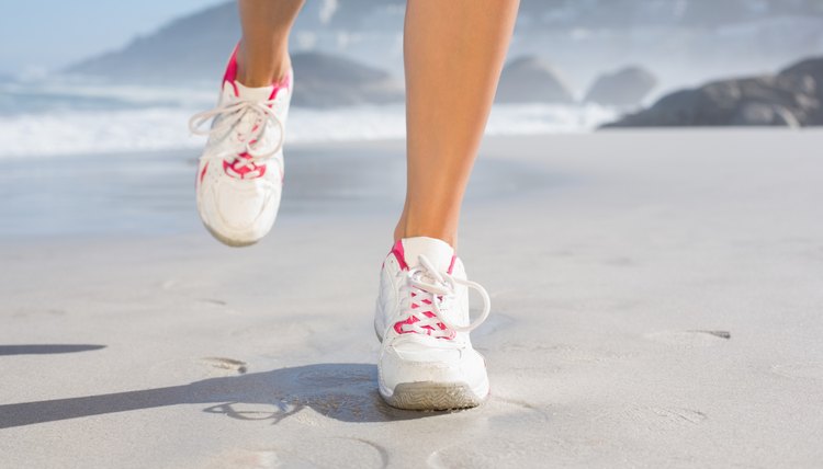 Fit woman walking on the beach