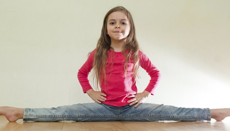 Little girl sits on a splits