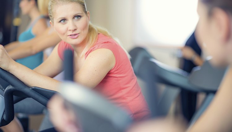 Women Talking While Using Exercise Machines